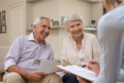 senior couple listening eagerly to the person talking