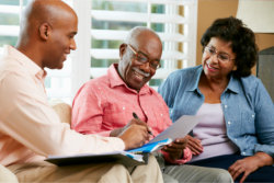 financial advisor talking to the senior couple at home