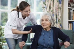 senior assisted by a caregiver